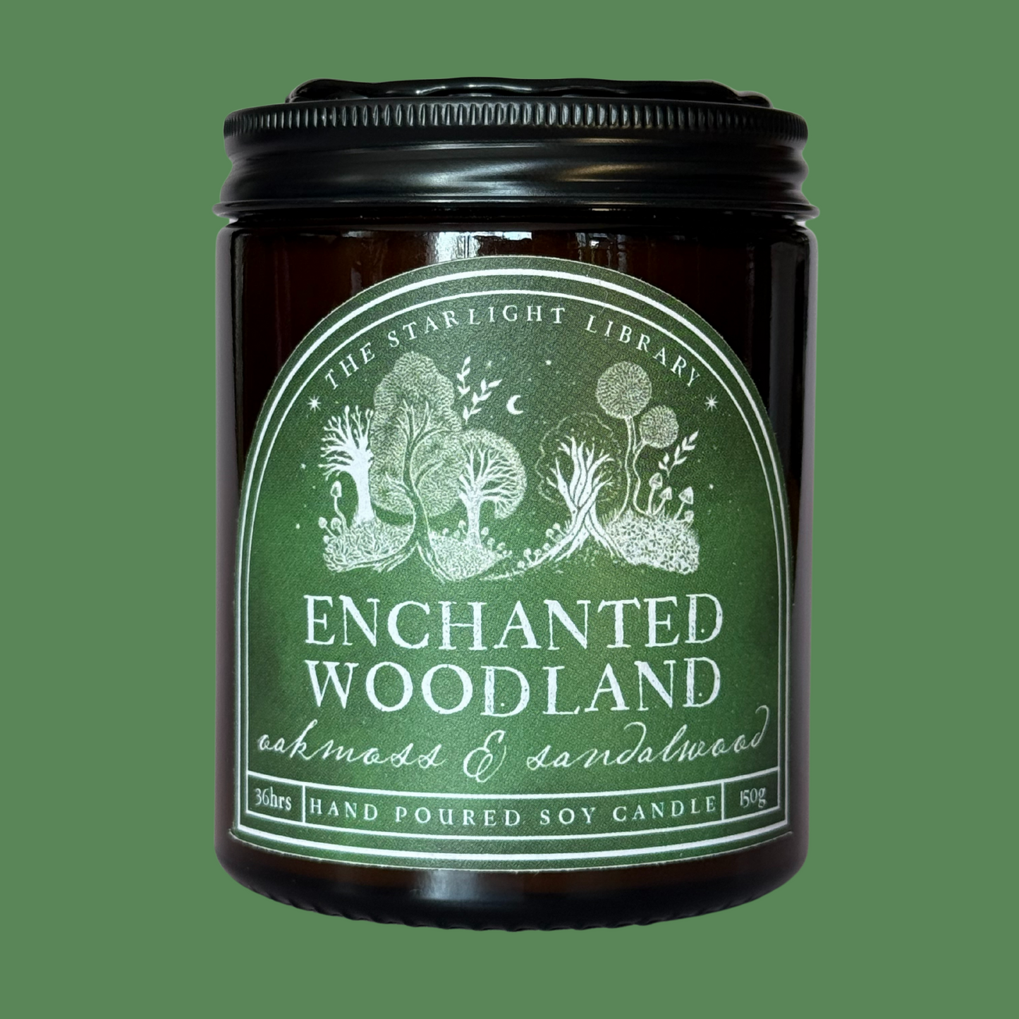An Enchanted Woodland candle against a matching green studio background.