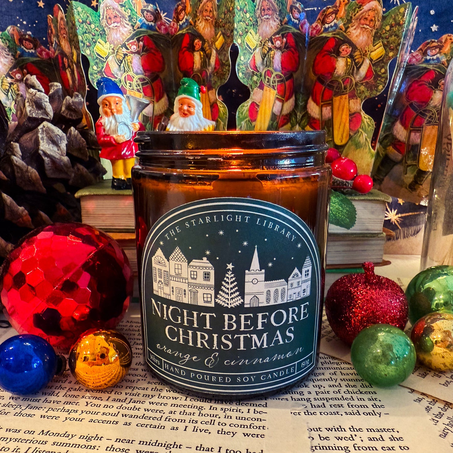 Candle labeled 'Night Before Christmas' with decorative elements on a starry night background