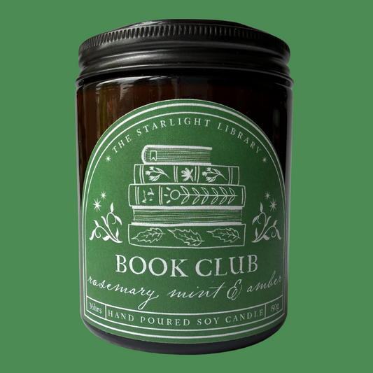 A Book Club Candle against a green studio background.