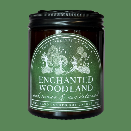 An Enchanted Woodland candle against a matching green studio background.