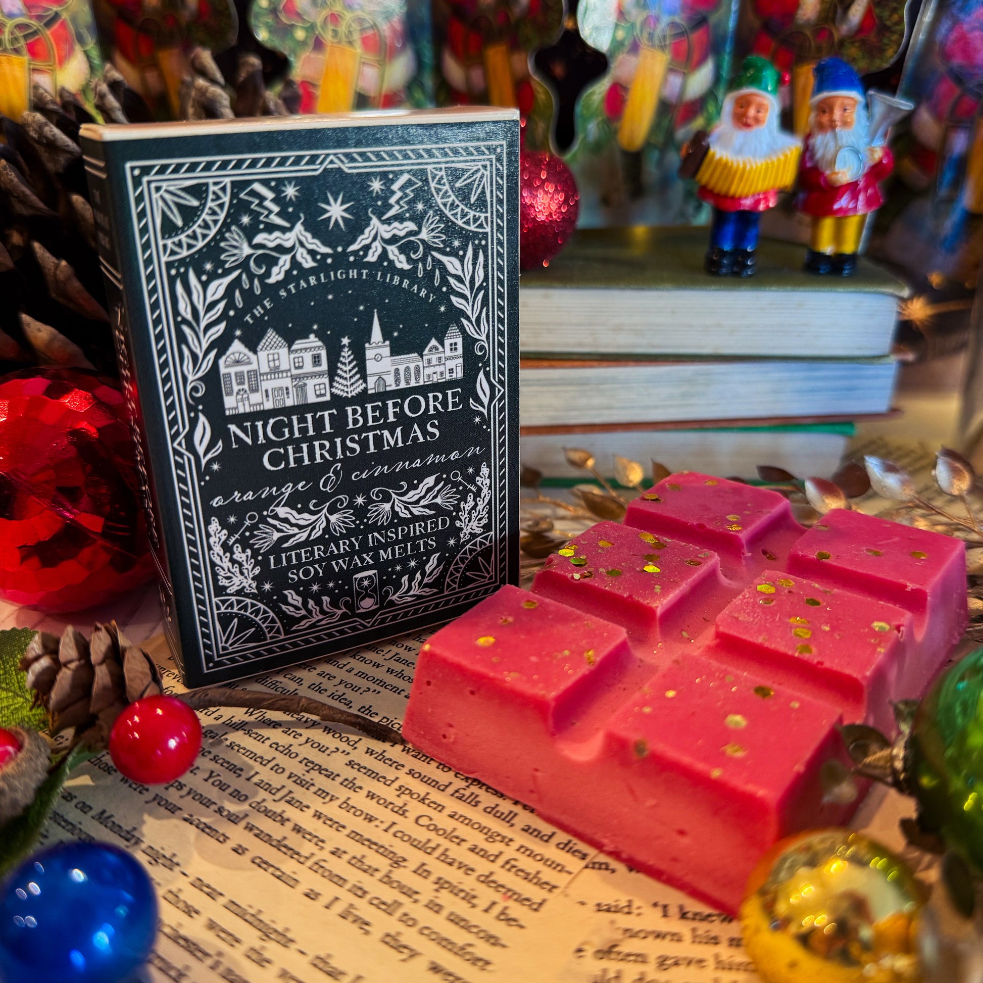 Red wax melts with 'Night Before Christmas' book and Santa Claus figurines in the background