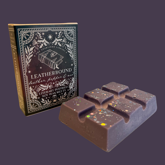 A Leatherbound wax melt bar against a dark purple studio background.