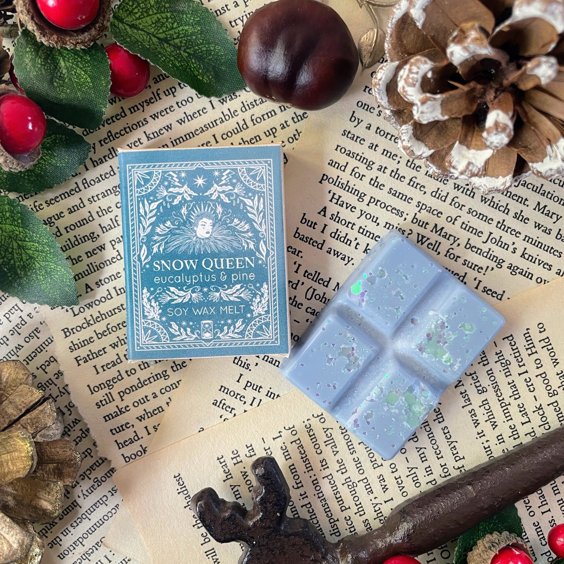 Snow Queen Mini Melt with packaging on a textured surface with decorative elements