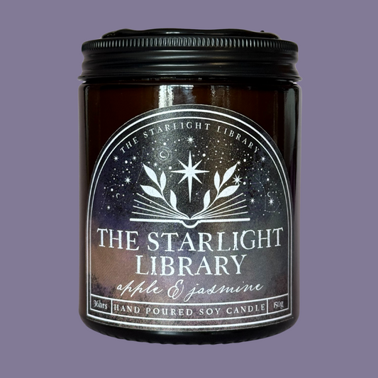 The Starlight Library candle against a matching smoky purple studio background.